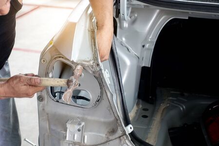 Align metal body car with hammer in automotive industry - auto body repair shopの写真素材