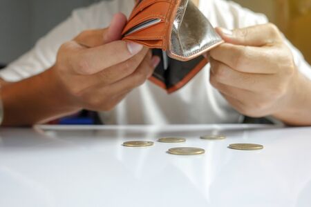 Coin falling from wallet - Little money concept - closeupの写真素材