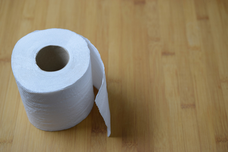 Toilet paper roll on wooden table - closeupの写真素材