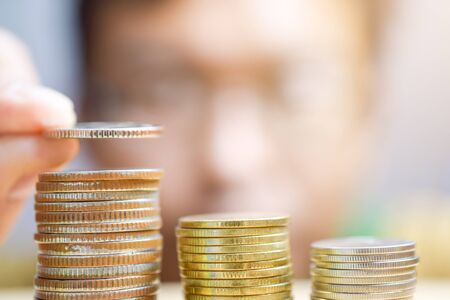 A man counts his coins on a table - closeupの写真素材