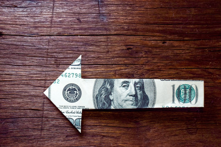 arrow money on wooden table - Financial direction conceptの写真素材