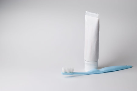 Toothbrush and tube on a white backgrund