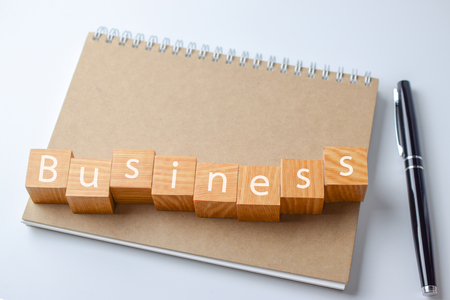 Wood block with business word on Notebook with pen - Business conceptの写真素材