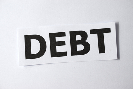 Word of DEBT on white paper, close-upの写真素材