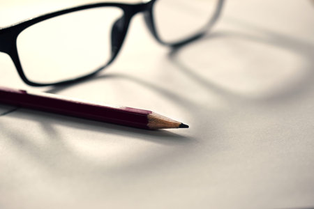 pencil on paper with glasses, office desk, close-upの写真素材