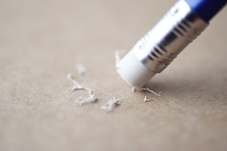 pencil eraser, pencil eraser removing a written mistake on a brown paper, delete, correct, and...
