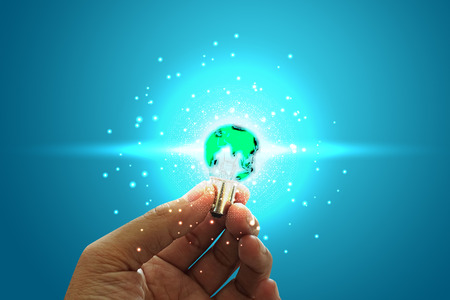 Innovative idea in businessman hand. Innovative idea concept. Green earth ligth bulb on handの写真素材