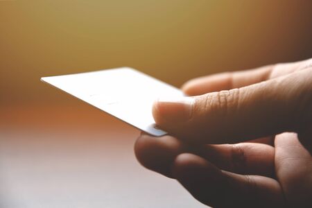 Closeup male hands holding credit cardの写真素材