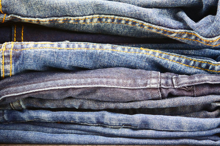 stack of blue jeansの写真素材