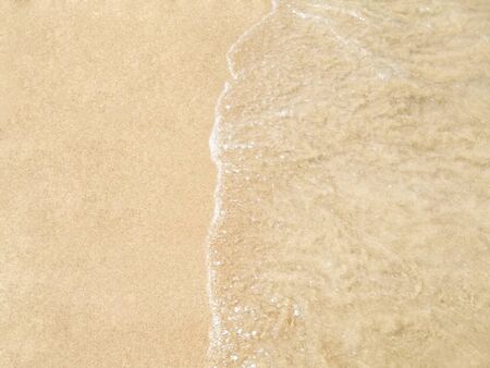 Clear water arrives to the coast on a sunny dayの写真素材