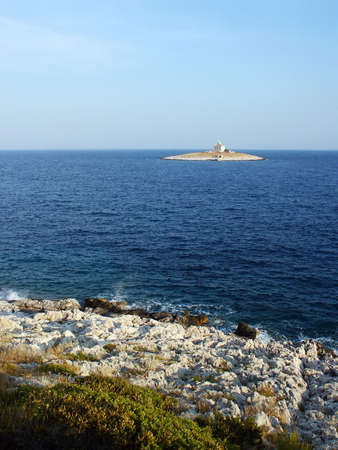 Lighthouse on island in adriatic seaの写真素材