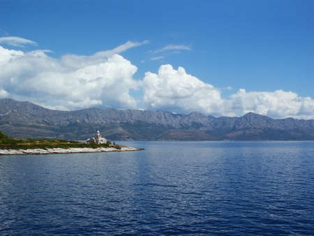 Lighthouse in blue adriatic sea under Biokovo mountain in south Adria, Croatiaの写真素材