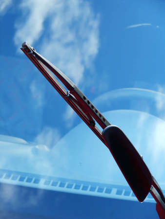 Car windshield wiper with clouds reflectionの写真素材