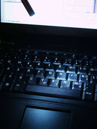 Late night work on laptop. Alight keyboardの写真素材