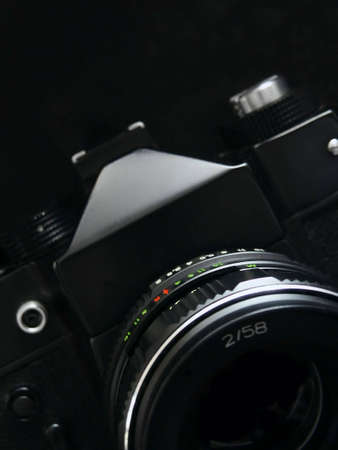 Old SLR camera isolated on black backgroundの写真素材