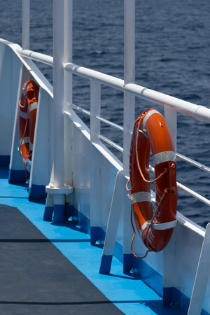 Two lifebuoys on fence of the ship deck with the sea in the background, small DOF, shallow focusの写真素材