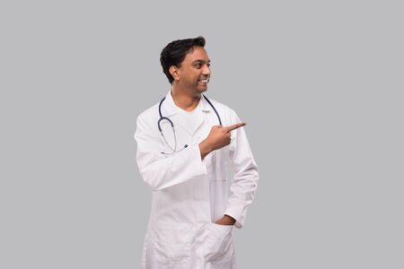 Indian Man Doctor Pointing to Side and Watching to Side. Isolatedの写真素材