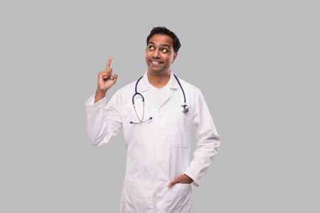 Indian Man Doctor Pointing Up and Watching Up. Isolatedの写真素材