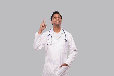 Indian Man Doctor Pointing Up and Watching Up. Isolatedの写真素材