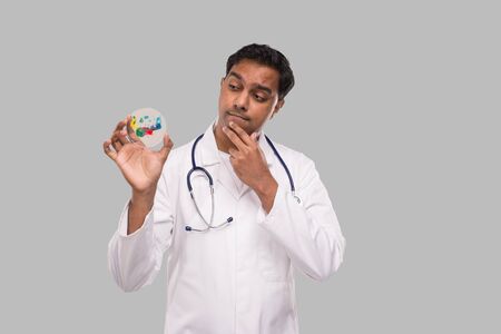 Indian Man Doctor Examing Petri Dish Isolated. Medicine, Science Conceptの写真素材
