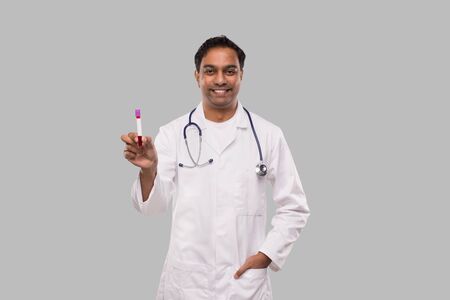 Indian Man Doctor Holding Blood Tube Analysis. Science, Medical Concept. Isolatedの写真素材