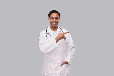 Doctor Pointing to Side and Watching Front. Isolatedの写真素材