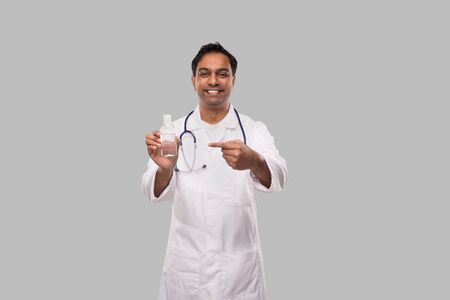 Doctor Pointing at Hands Sanitizer. Hands Wash Antiseptic. Corona Virus Concept. Isolatedの写真素材