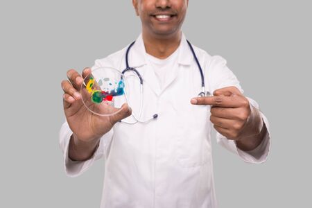 Doctor Pointing at Petri Dish Smilling Isolated Close Up. Medicine, Science Conceptの写真素材