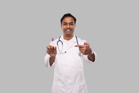 Indian Man Doctor Pointing at Blood Tube Analysis. Science, Medical Concept. Isolatedの写真素材