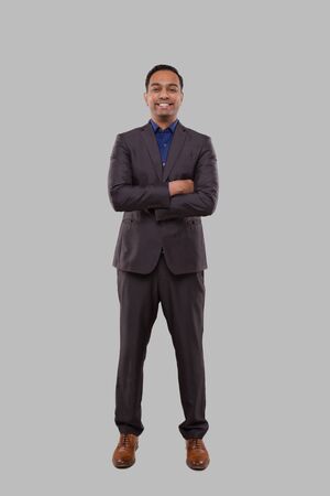 Businessman Smilling Hands Crossed Isolated. Indian Businessman Standing Full Lengthの写真素材