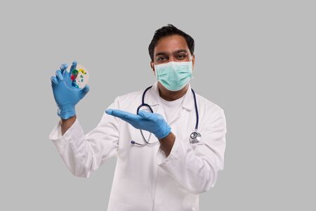 Doctor Holding Petri Dish Wearing Medical Mask and Gloves Isolated. Medicine, Science Conceptの写真素材