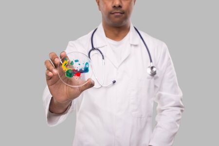 Doctor Holding Petri Dish Isolated Close Up. Medicine, Science Conceptの写真素材
