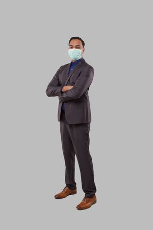 Businessman Hands Crossed Wearing Medical Mask Isolated. Indian Businessman Standing Full Lengthの写真素材