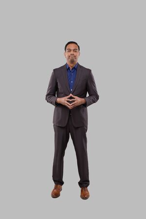 Businessman Smilling Hands in Front of Chest Isolated. Indian Businessman Standing Full Length. Business Poseの写真素材