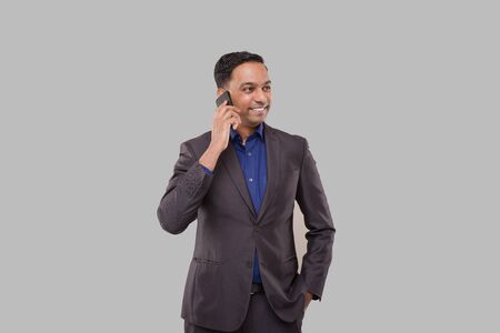 Businessman Talking on Phone Isolated. Indian Businessman Standing Full Lengthの写真素材