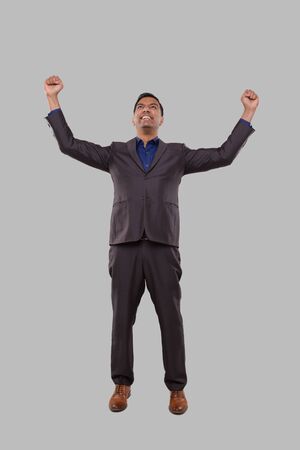 Businessman Very Happy and Excited, Raising arms, Celebrating a Victory or Success. Winner Sign. Indian Business man Isolatedの写真素材