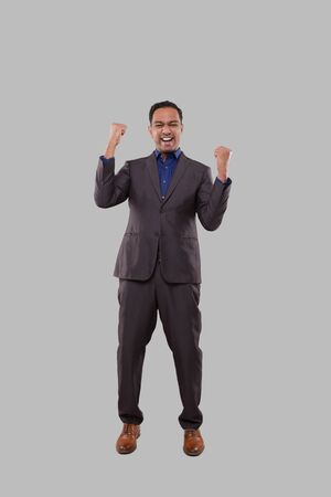Businessman Very Happy and Excited, Raising arms, Celebrating a Victory or Success. Winner Sign. Indian Business man Isolatedの写真素材
