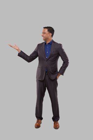 Businessman Showing to Side Isolated. Indian Man Standing Full Lenghtの写真素材