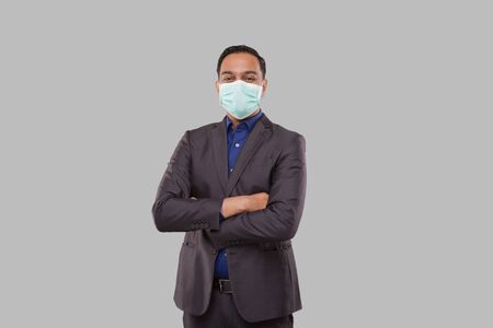 Businessman Hands Crossed Wearing Medical Mask Isolated. Indian Businessman Standingの写真素材