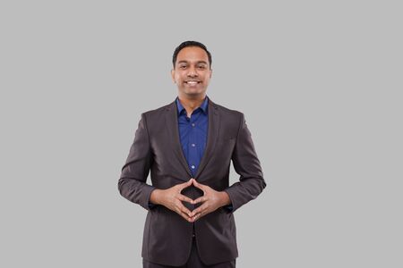 Businessman Smilling Hands in Front of Chest Isolated. Indian Business man Standing Business Poseの写真素材
