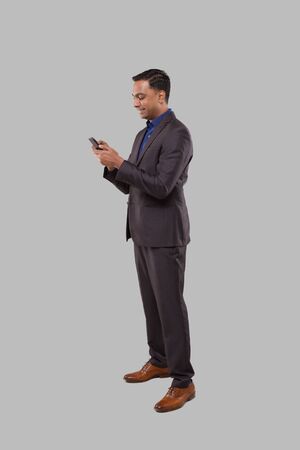 Businessman Chatting on Phone Isolated. Indian Business man using Phoneの写真素材