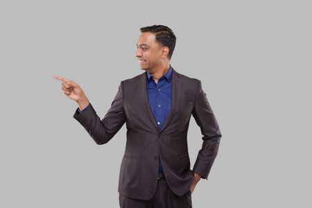 Businessman Pointing to Side Isolated. Indian Man Standingの写真素材