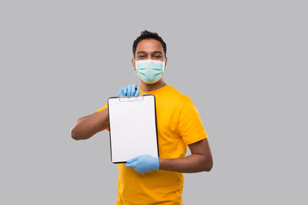 Indian Man Holding clipboard Wearing Medical Mask and Gloves Watching in Camera. Indian Delivery Boy...