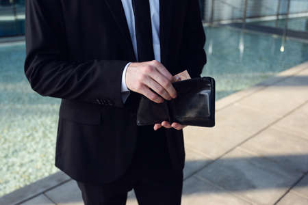 Businessman Counting Money in Wallet. Money Concept, Businessman Freelance. Wallet in hands Close upの写真素材