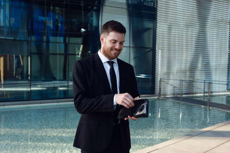 Businessman Counting Money in Wallet. Money Concept, Businessman Freelance. Wallet in hands.の写真素材