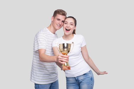 Couple Holding Trophy Happy Isolated. Couple Goals. Winnersの写真素材