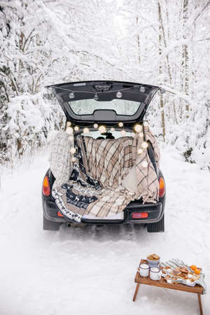 Winter Picnic Set Up in Car. Snow Forest Picnic. Love Story in Natureの写真素材
