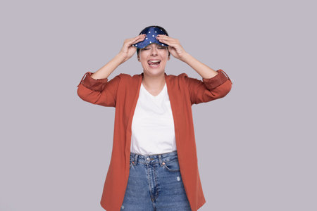 Girl Taking of Sleeping Mask Makes Grimaces. Funny Girlの写真素材