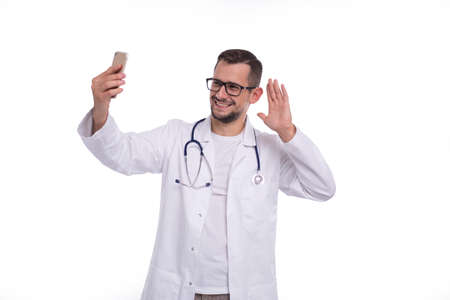 Doctor Having Video Call on Phone Isolated. Man Doctor Video Call. Medicine Online. Doctor Using Phone.の写真素材