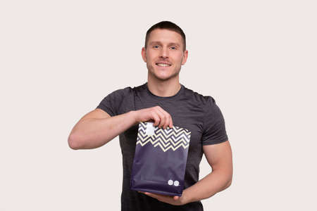 Sport Man Holding Sport Food. Sportsman Holding Protein Packの写真素材